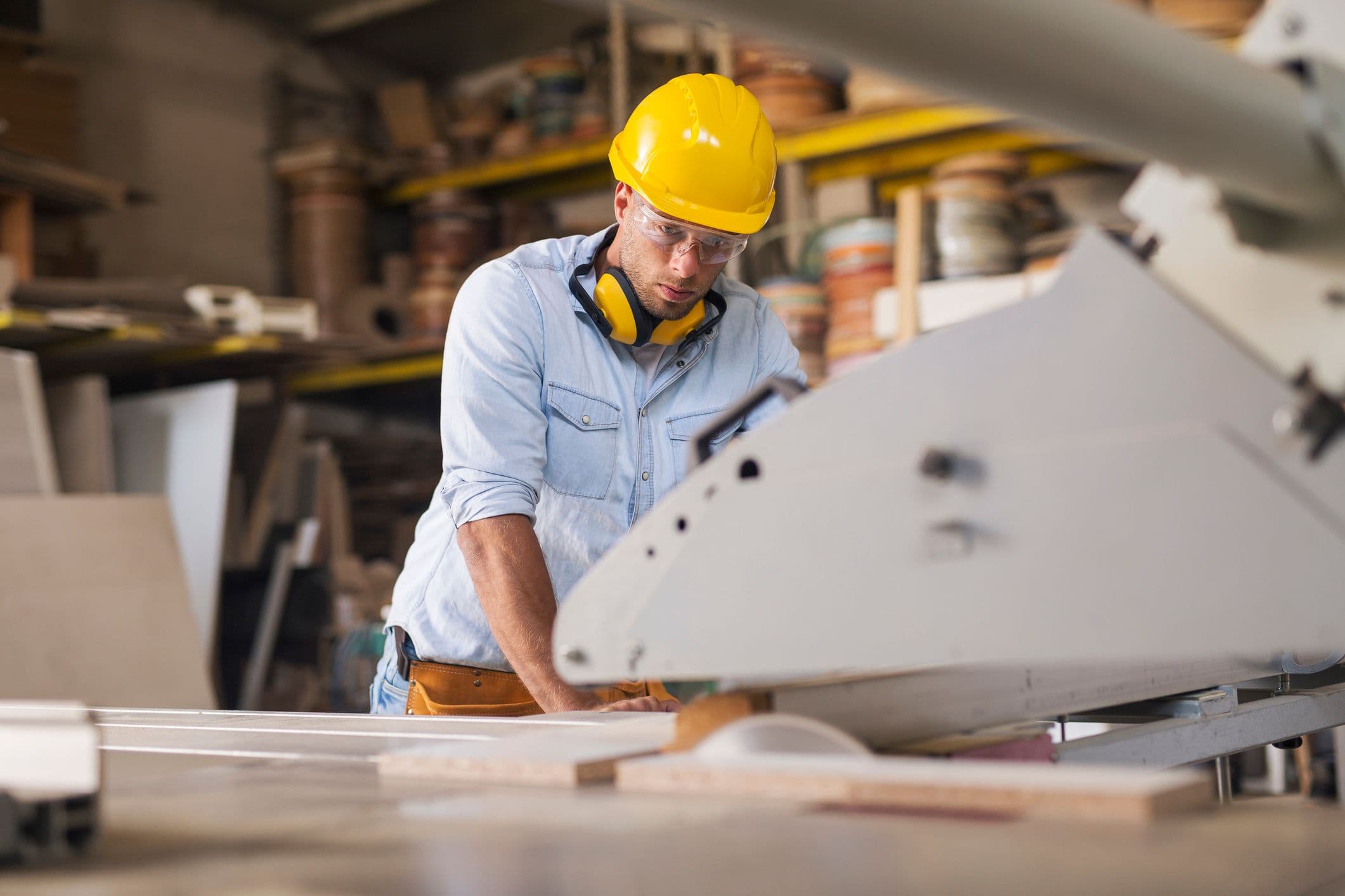 Concentrated carpenter using timber processing machine in workshop